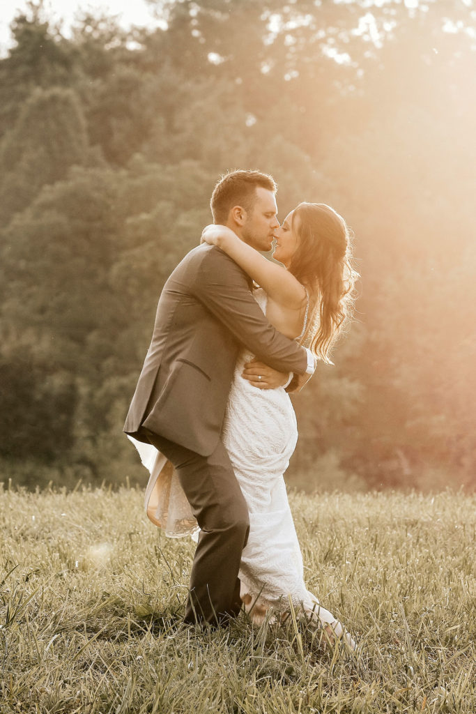Bride and Groom in Lush Field Bride and Groom Hugging in Lush Field